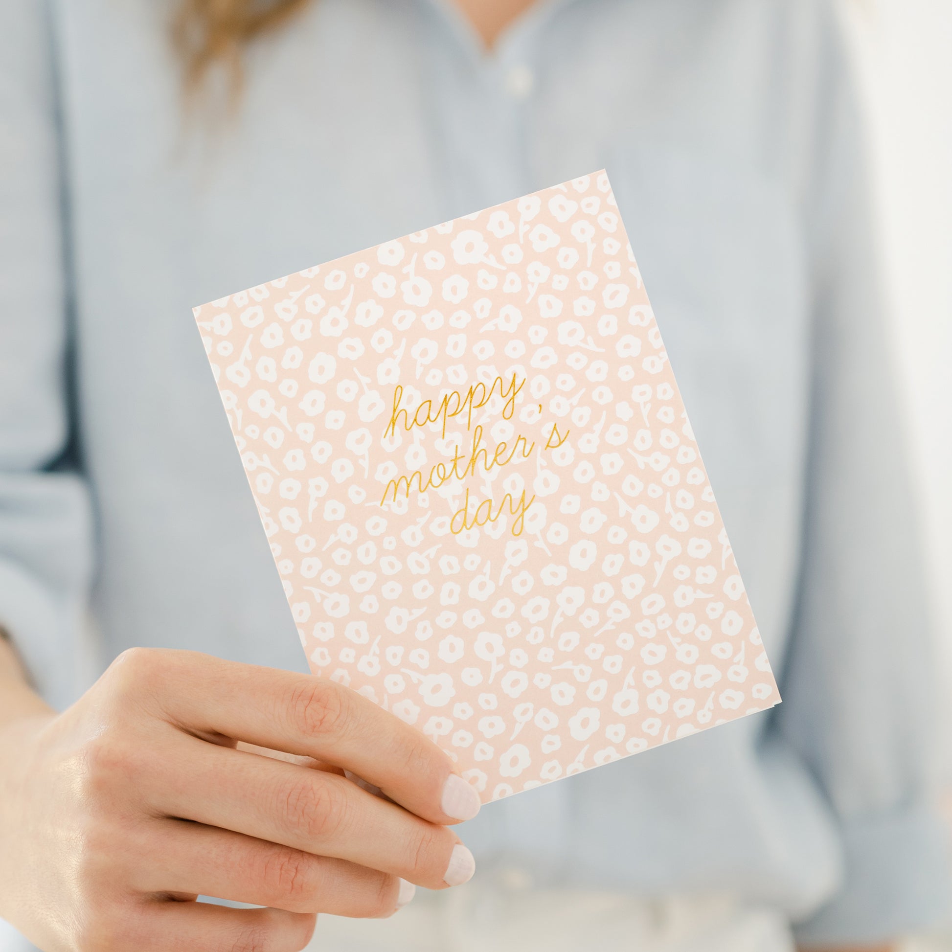 person holding floral happy mother's day card