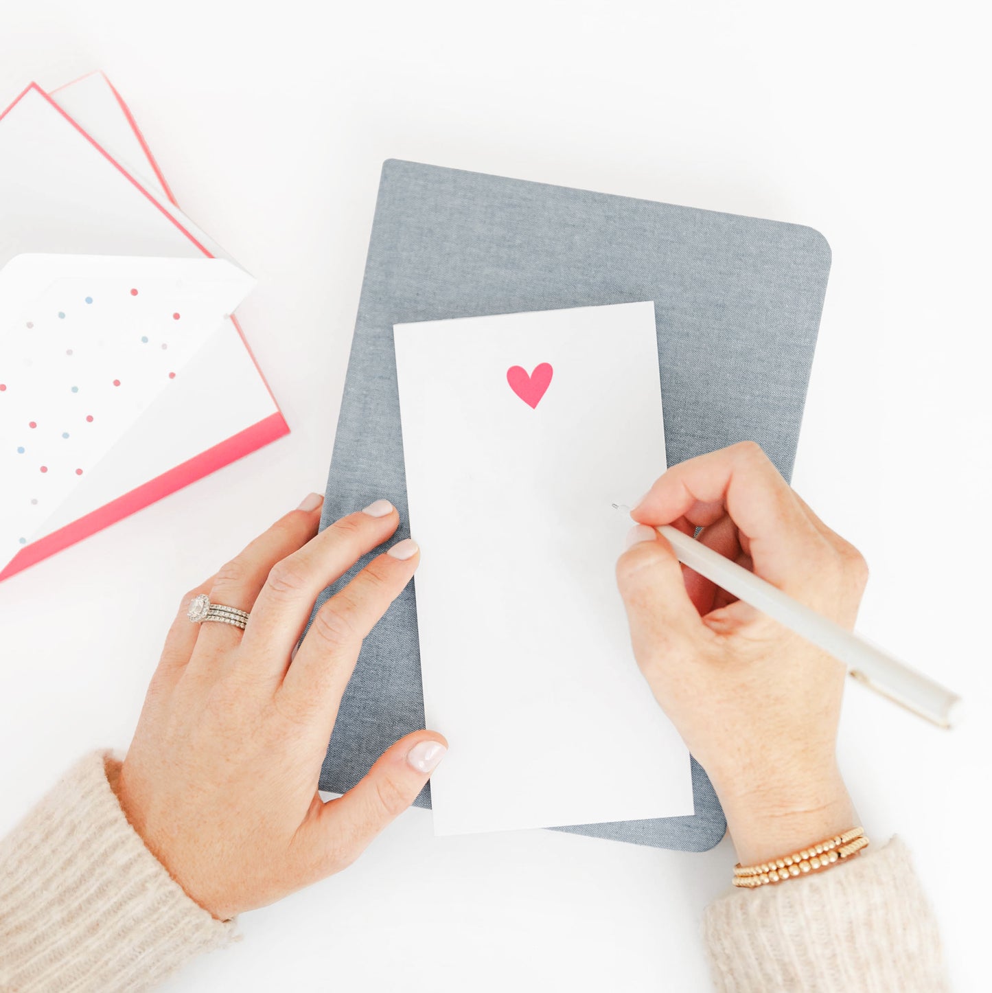 Woman writing on neon pink notepad