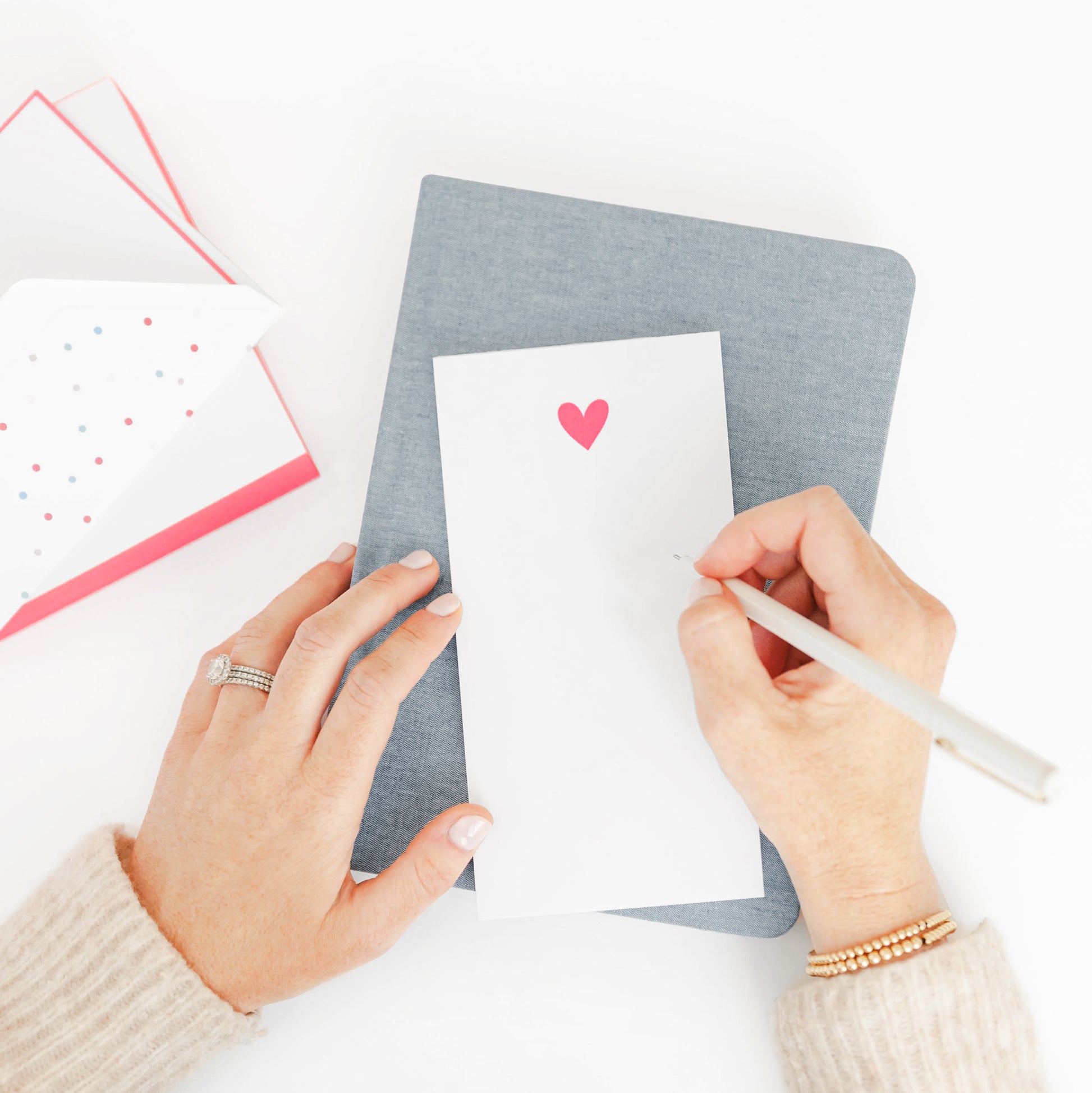 Woman writing on neon pink notepad