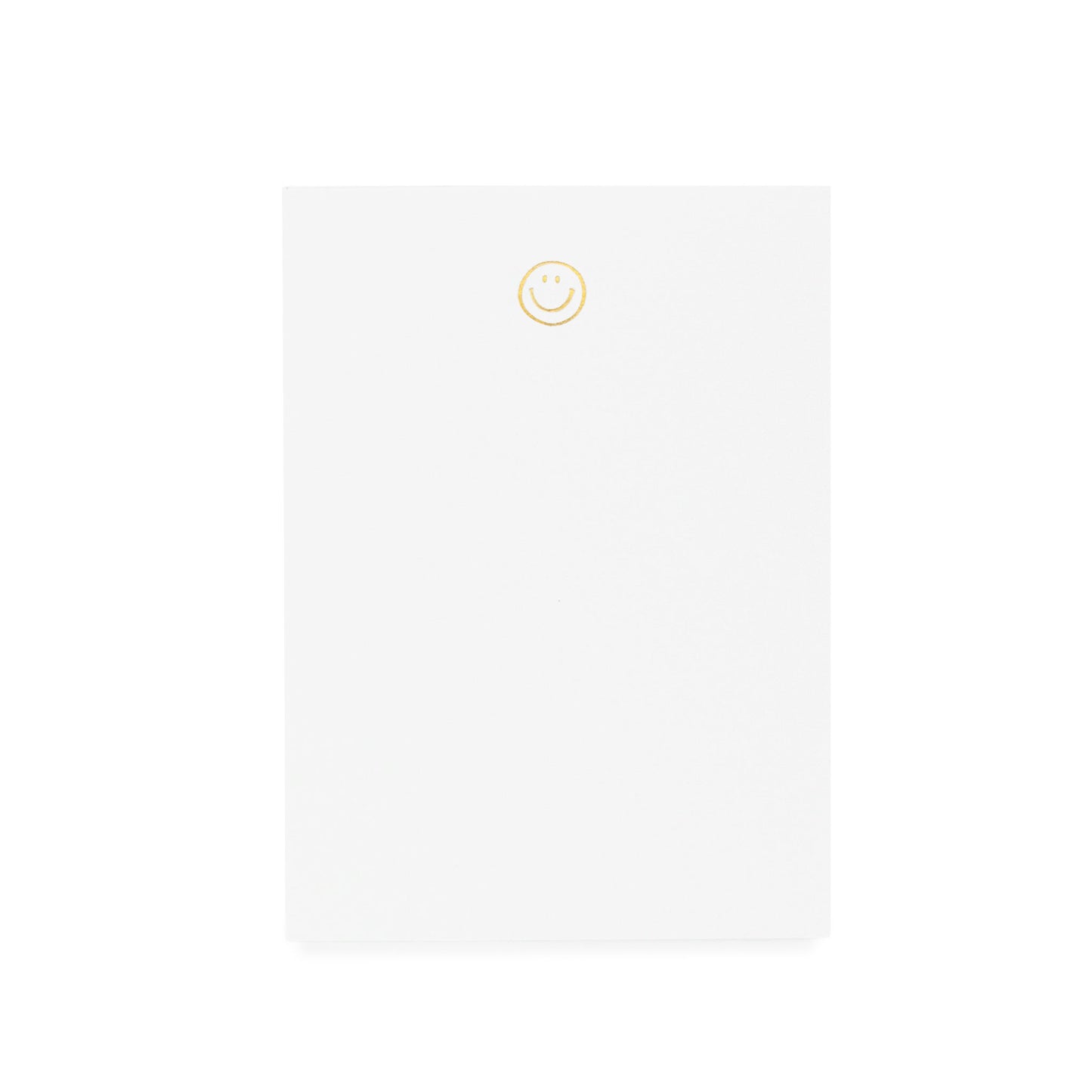 White notepad printed with gold foil smiley
