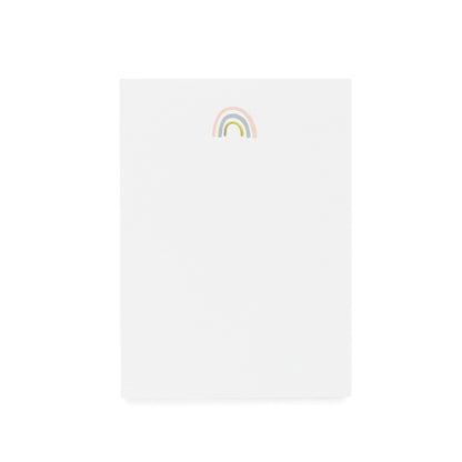 White notepad printed with pink blue and gold foil rainbow