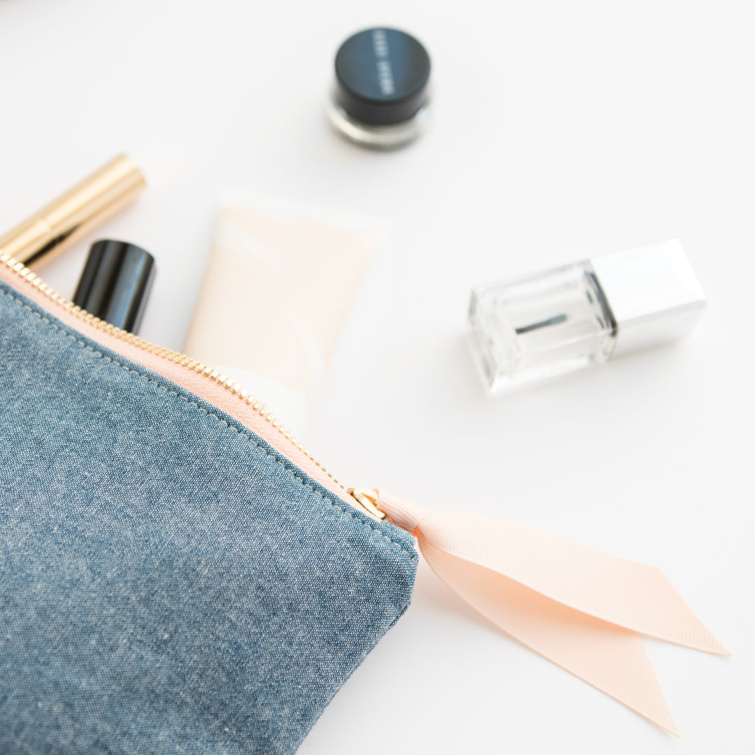 chambray pouch with toiletries