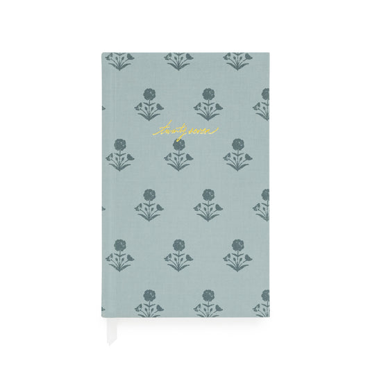 Fabric bound agenda with a dusty blue fabric and dark blue floral pattern with 'twenty-seven' foil stamped on the cover with two white ribbon markers