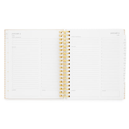 An open spiral-bound planner showing two white pages with grey text and daily planning pages with 'today's priorities,' 'the list,' 'grateful for'