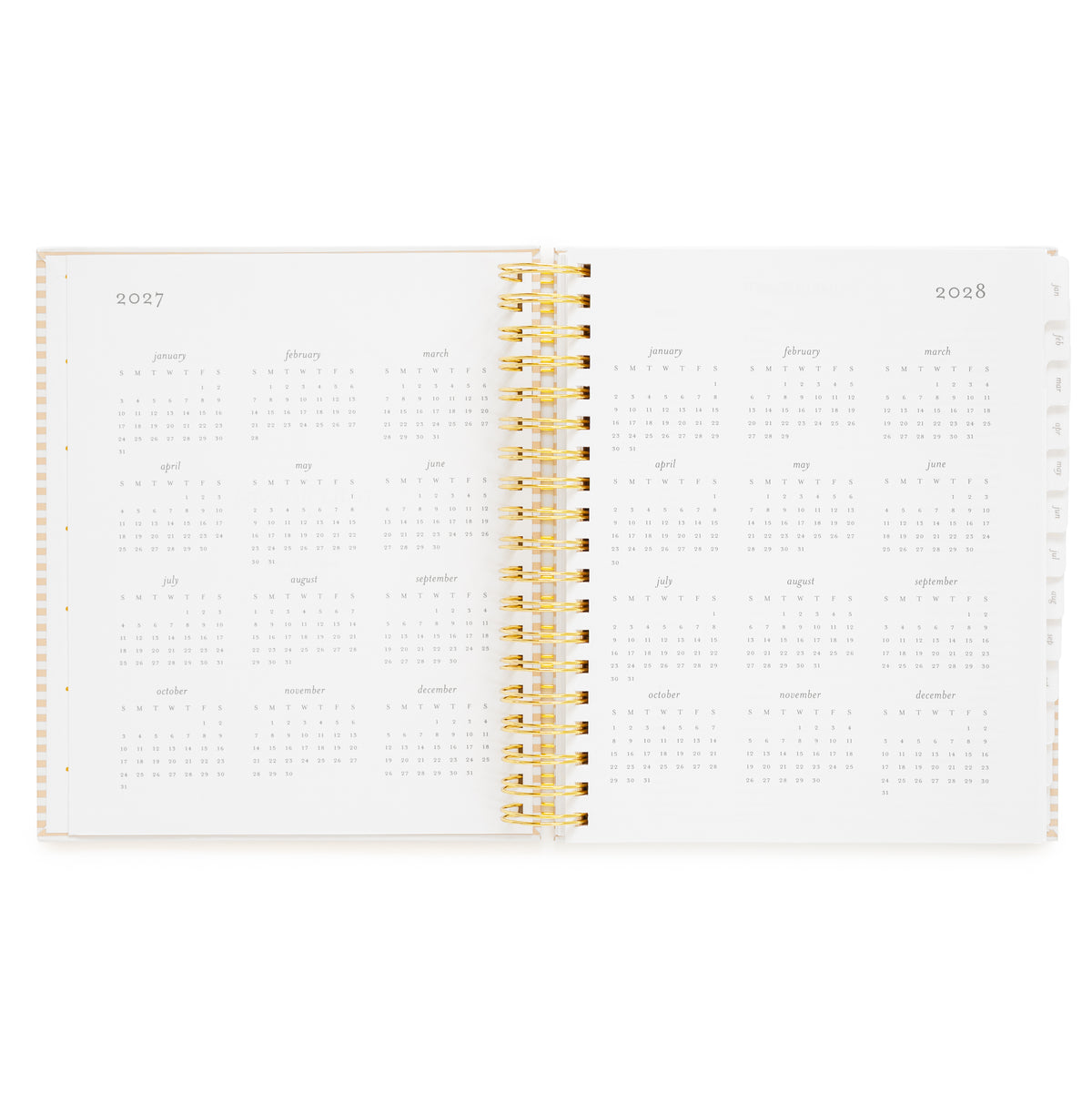 An open spiral-bound planner showing the years 2027 and 2028 with monthly grids and a gold spiral in the middle