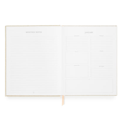 An open monthly planner with lined 'MONTHLY NOTES' pages on the left and a structured 'JANUARY' calendar layout on the right