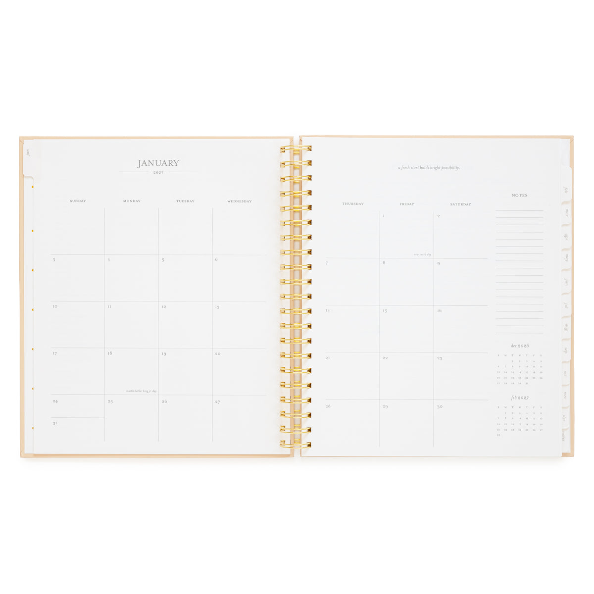 An open spiral-bound planner showing blank January page spread with boxes for the whole month and notes section on the right 