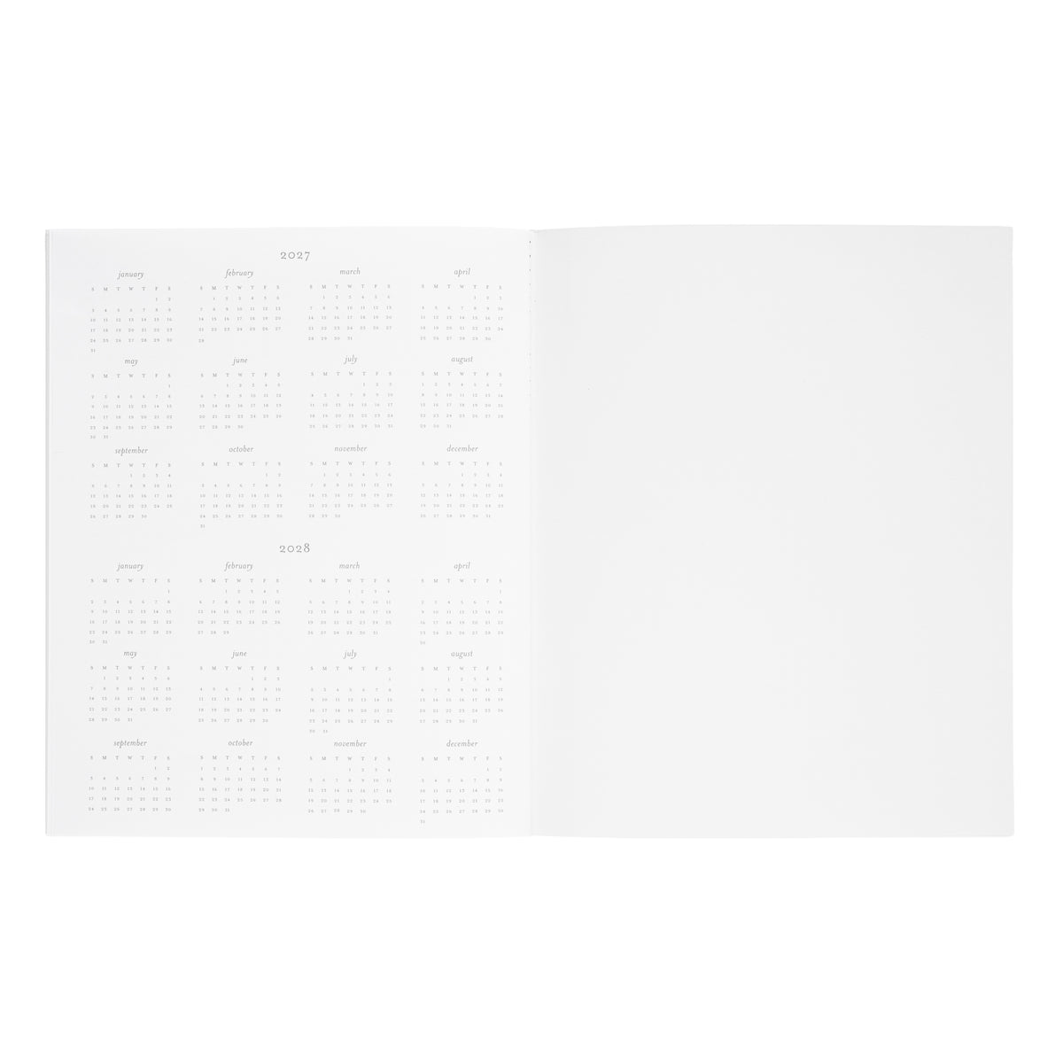 An open white planner with monthly grid showing the overview of 2027 and 2028 dates