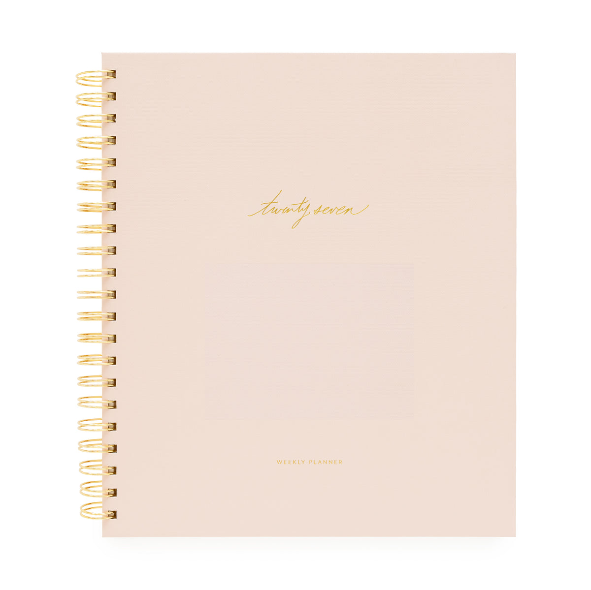 A blush pink spiral-bound planner with gold wire binding and gold foil text on the cover with 'twenty-seven' and 'weekly planner'