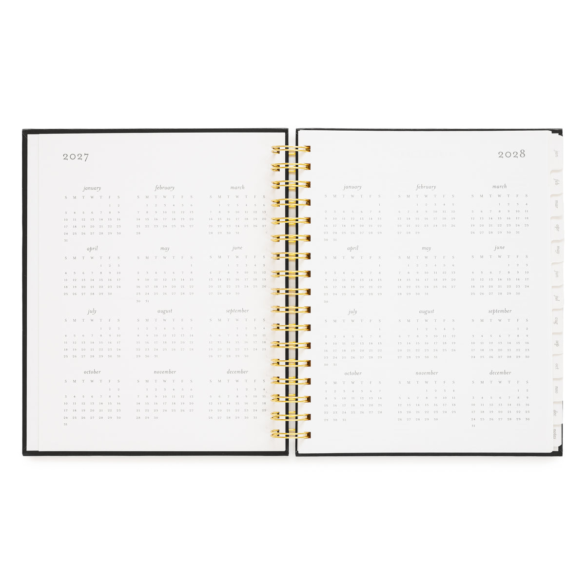 An open spiral-bound planner showing the years 2027 and 2028 with monthly calendar grids on white pages