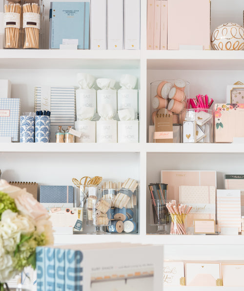 Close up of styled merchandise in shelves in the store featuring hues of blue and pink