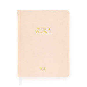 Pale pink weekly planner with gold foil initials