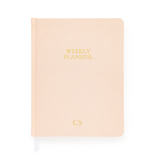 Pale pink weekly planner with gold foil initials