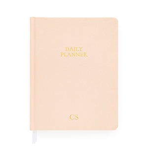 Pale pink daily planner with gold monogram initials