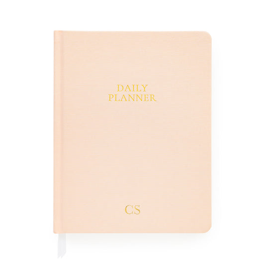Pale pink daily planner with gold monogram initials