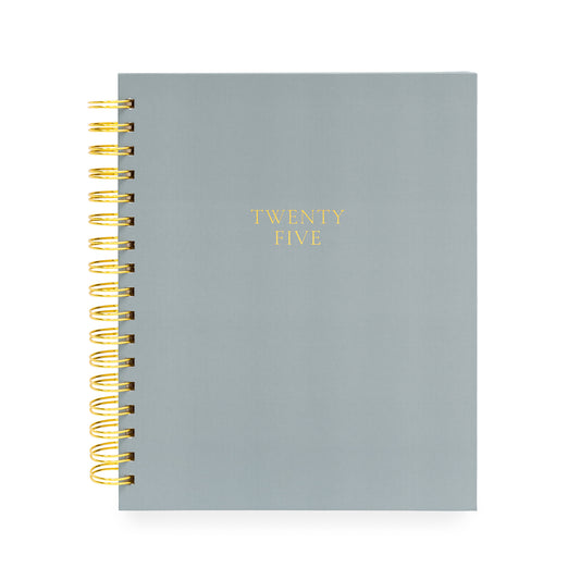 Dusty blueish grey spiral planner foil stamped with Twenty Five in gold on cover
