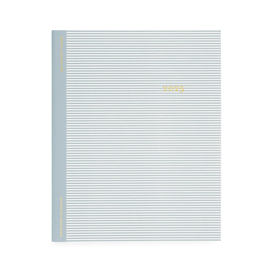 Dusty blue and white stripe monthly planner foil stamped in gold with 2025 on the cover