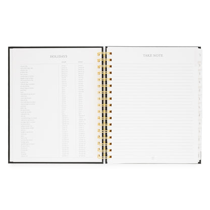 Open spiral-bound planner with 2026 + 2027 'Holidays' and 'Take Note' sections