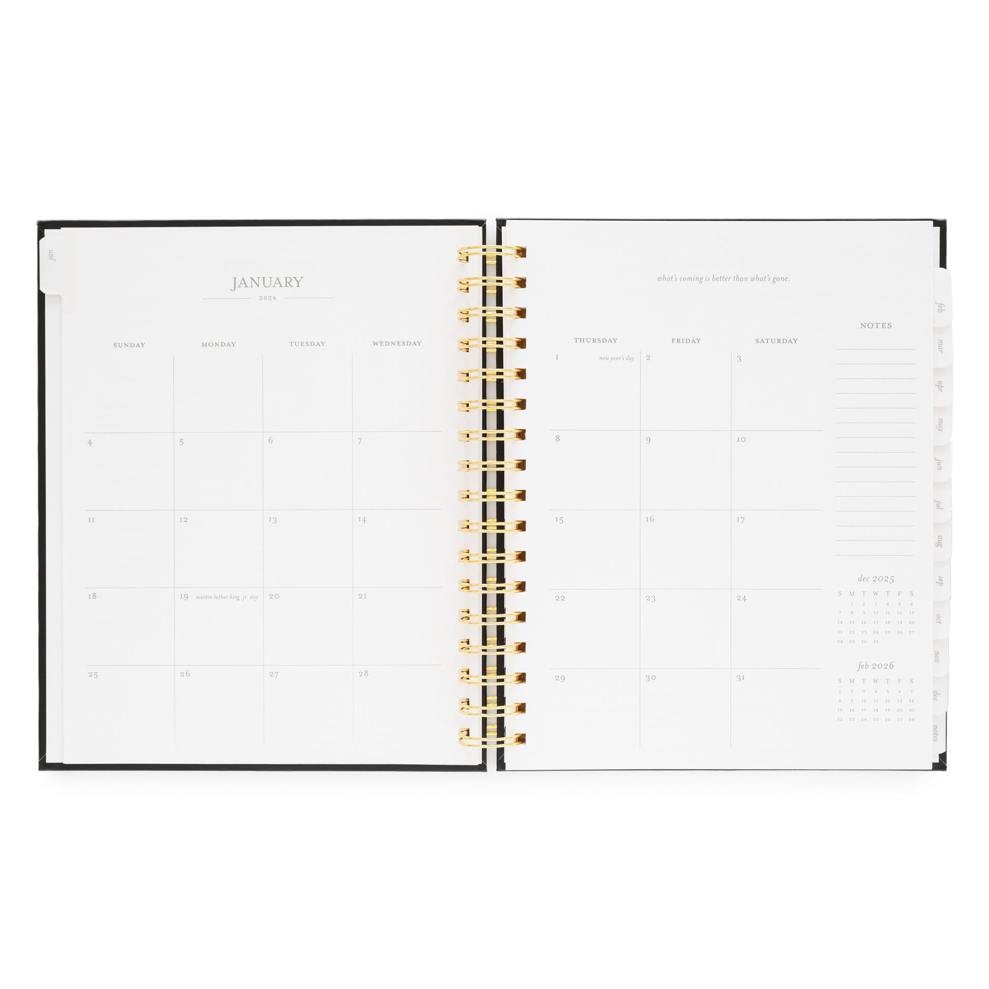 Open spiral planner showing a monthly layout for January 2026 with a gold spiral binding
