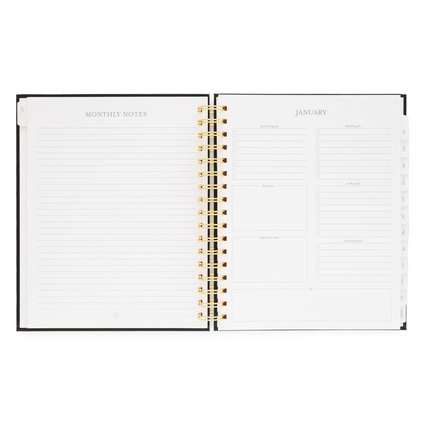 Open spiral planner showing monthly notes page and January 2026 monthly goal prompts
