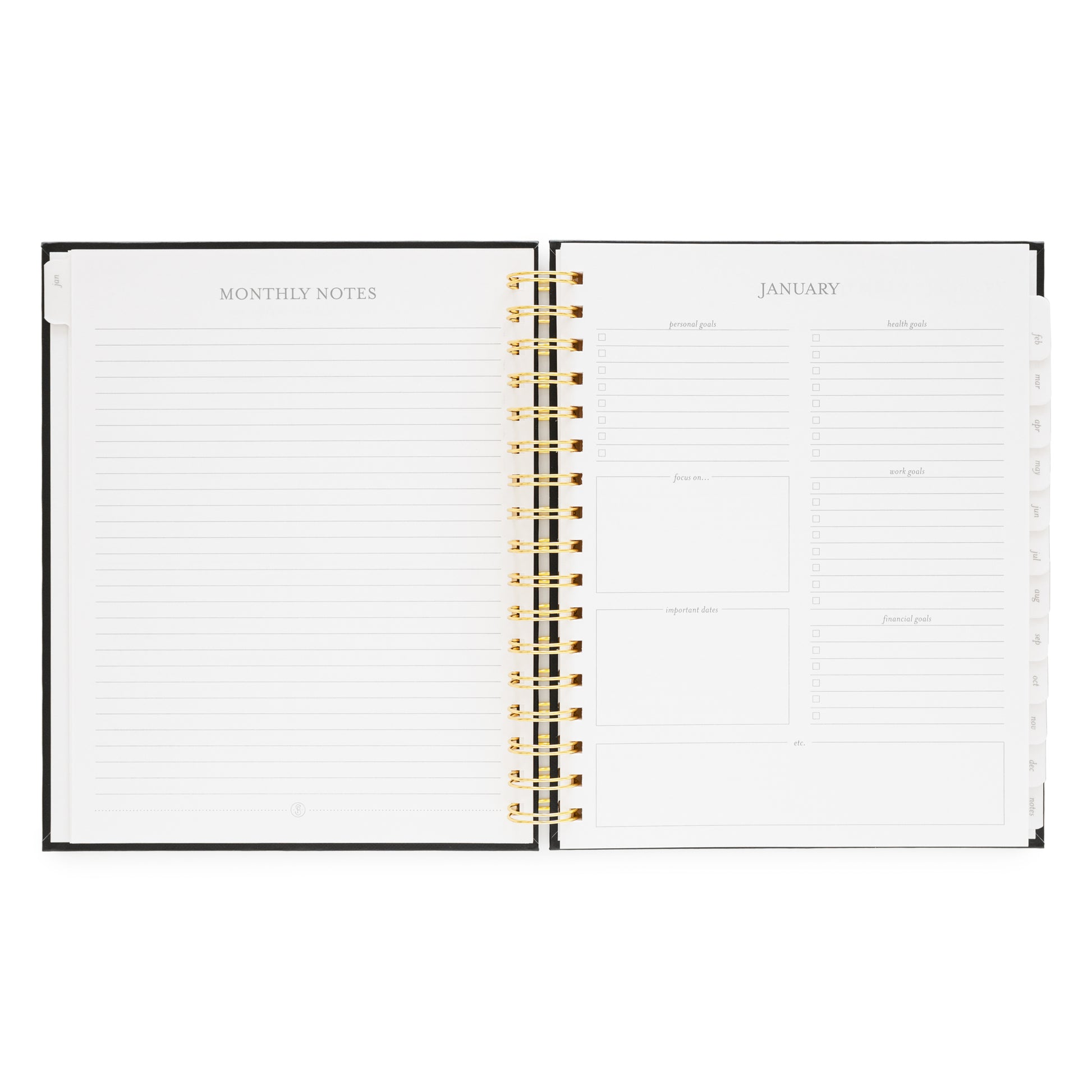 Open spiral planner showing monthly notes page and January 2026 monthly goal prompts
