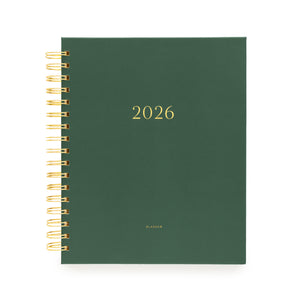Forest green planner with gold spiral binding stamped with 2026 on the cover