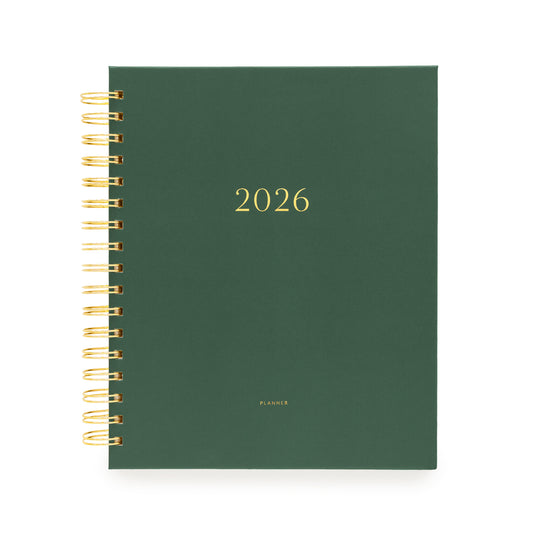 Forest green planner with gold spiral binding stamped with 2026 on the cover