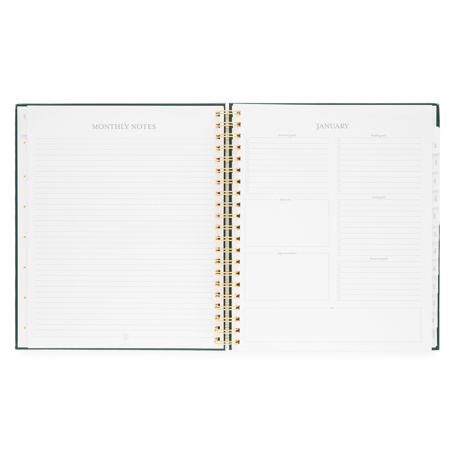 Open large weekly spiral-bound planner showing monthly notes and goals for January 2026
