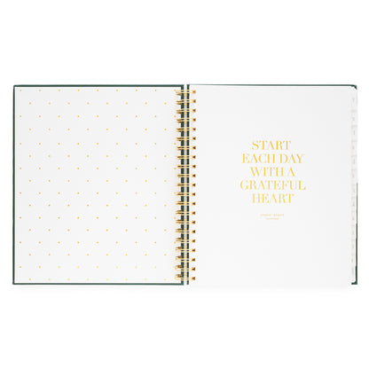 Open spiral-bound planner with polka dot pages foil printed with "start each day with a grateful heart"
