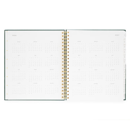 Open large weekly spiral planner with 2026 + 2027 month overview