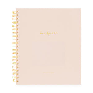 Blush planner with gold spiral binding and 'twenty-six' on cover