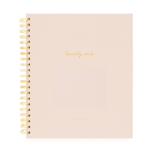 Blush planner with gold spiral binding and 'twenty-six' on cover