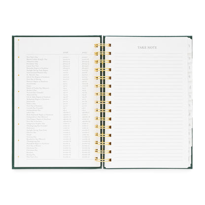 Open small spiral planner with lined pages and 2026 + 2027 holidays