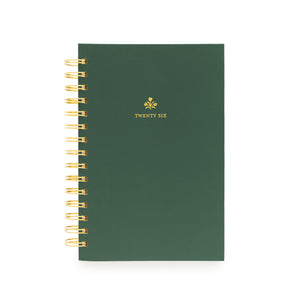 Small green planner with gold spiral binding with "twenty six" in gold foil on the cover