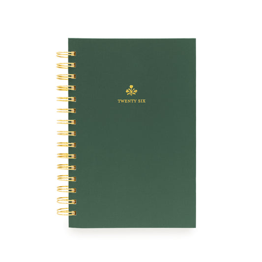 Small green planner with gold spiral binding with "twenty six" in gold foil on the cover