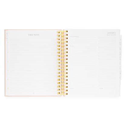 Open spiral planner with lined pages and gold spiral binding with daily page with today's priorities, the list, grateful for, timed slots for planning, and dinner plans