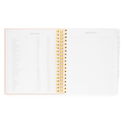 Open spiral planner with 2026 + 2027 holidays and take note pages