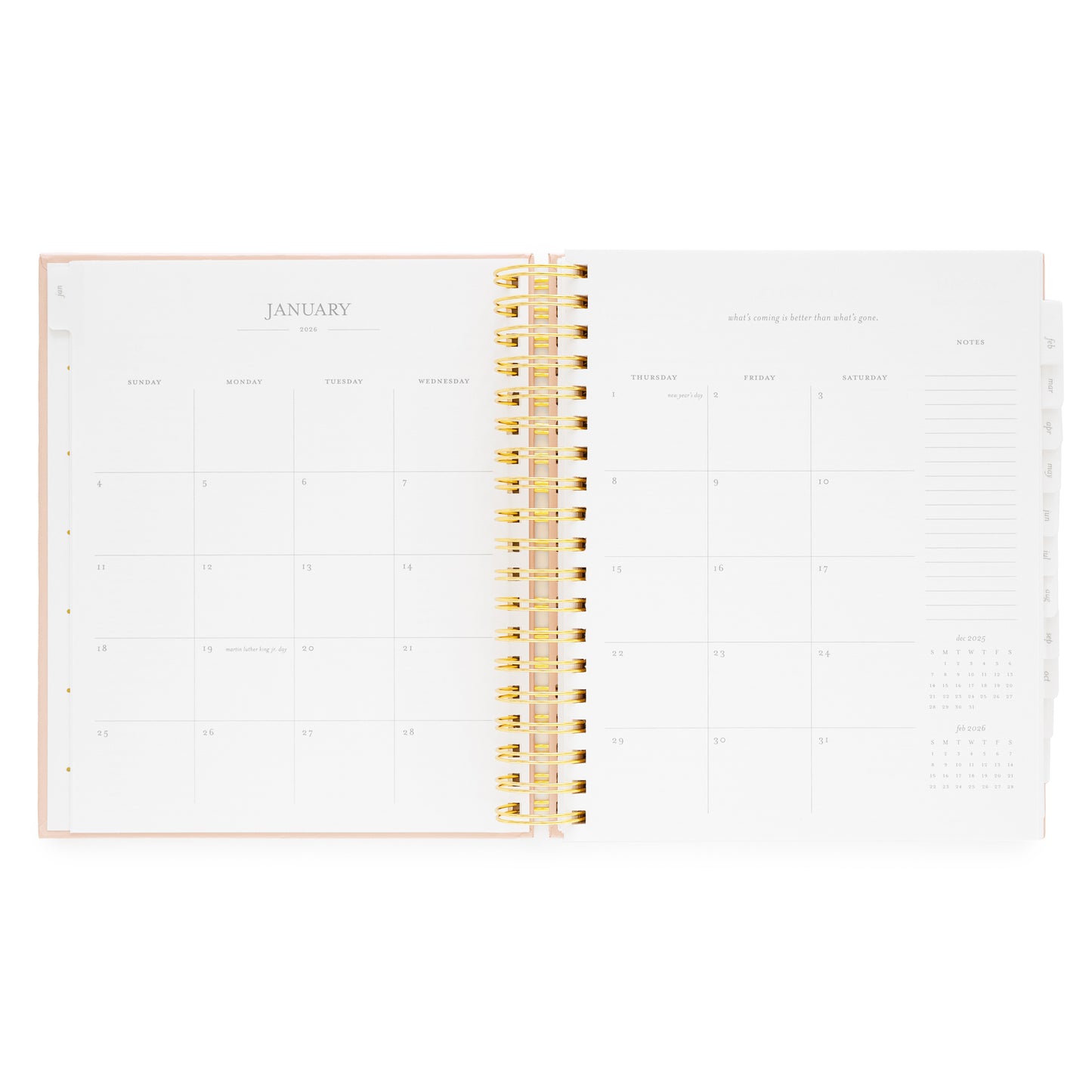 Open spiral planner showing january monthly calendar with a gold spiral binding