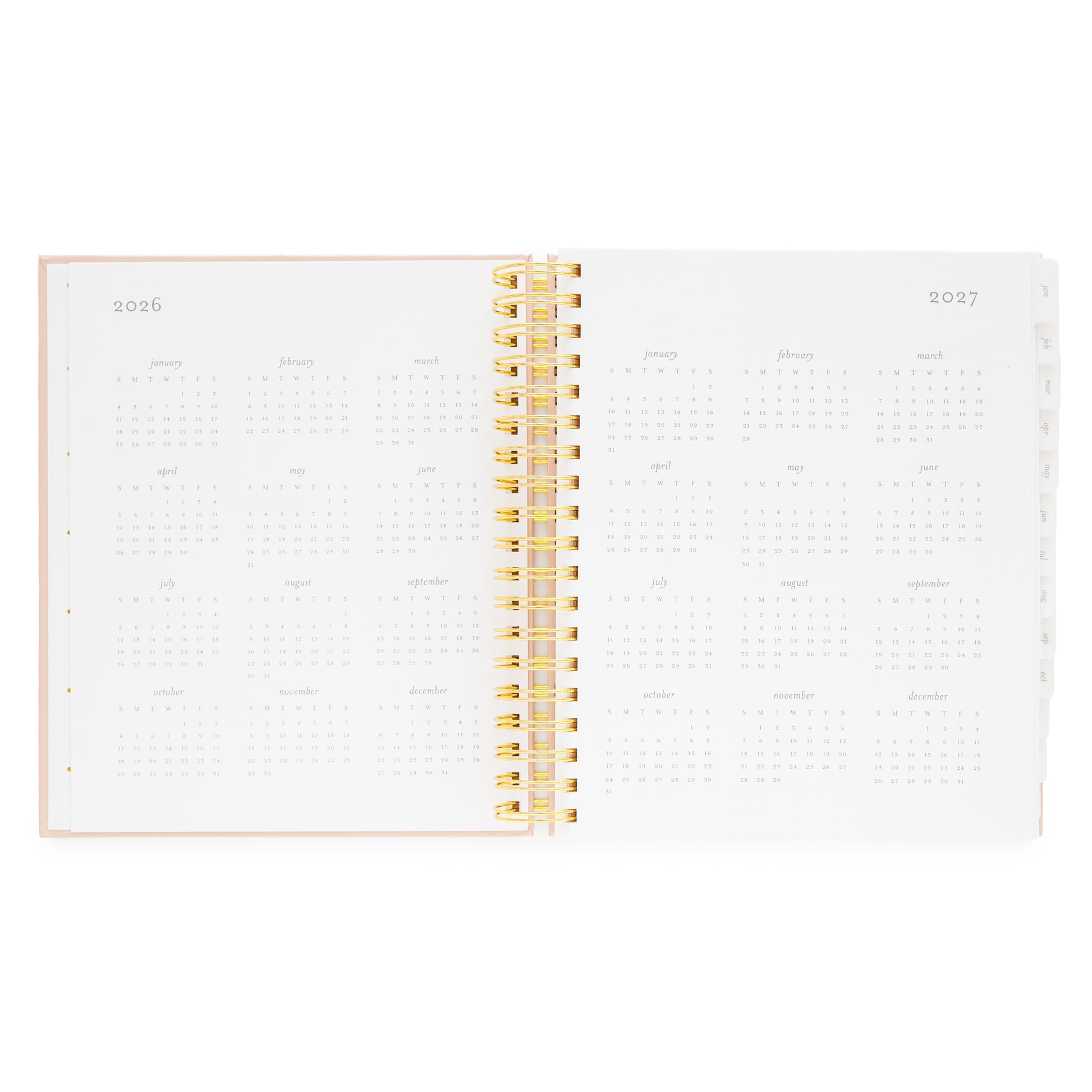Open spiral planner with gold spiral binding and 2026 + 2027 months