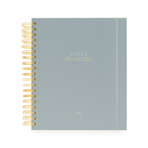 Light blue daily planner with gold spiral binding and daily planner and 2026 foil stamped in gold on cover