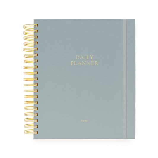 Light blue daily planner with gold spiral binding and daily planner and 2026 foil stamped in gold on cover