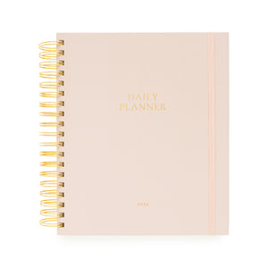 Blush pink daily planner with gold spiral binding and daily planner and 2026 in gold foil on the cover