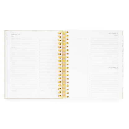 Open spiral planner with daily with today's priorities, the list, grateful for, timed slots for each weekday, and dinner plans, and extra space and blank notes for weekend days