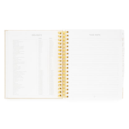 Open spiral-bound planner with '2026 + 2027 Holidays' and 'Take Note' sections