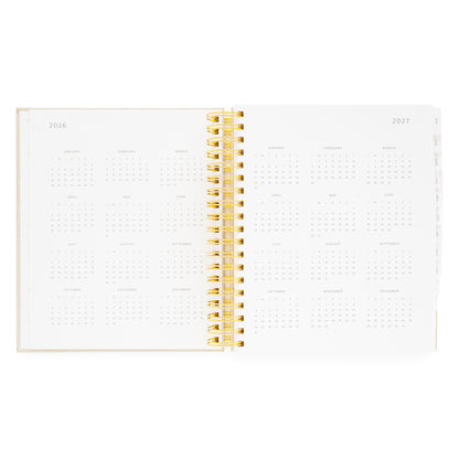 Open daily spiral planner with 2026 + 2027 months