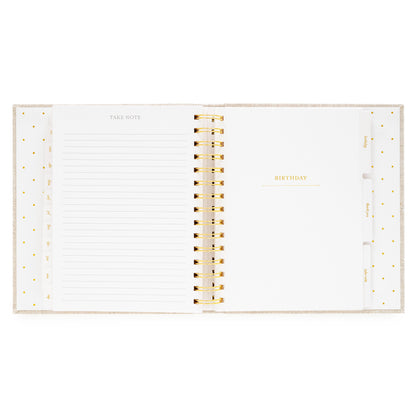 Open concealed agenda with gold spiral with take note and ruled lines and birthday introduction section
