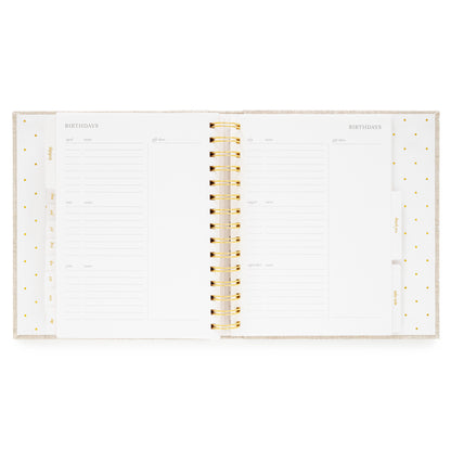 Open concealed agenda with gold spiral and pages for birthday tracking with date, name and gift idea
