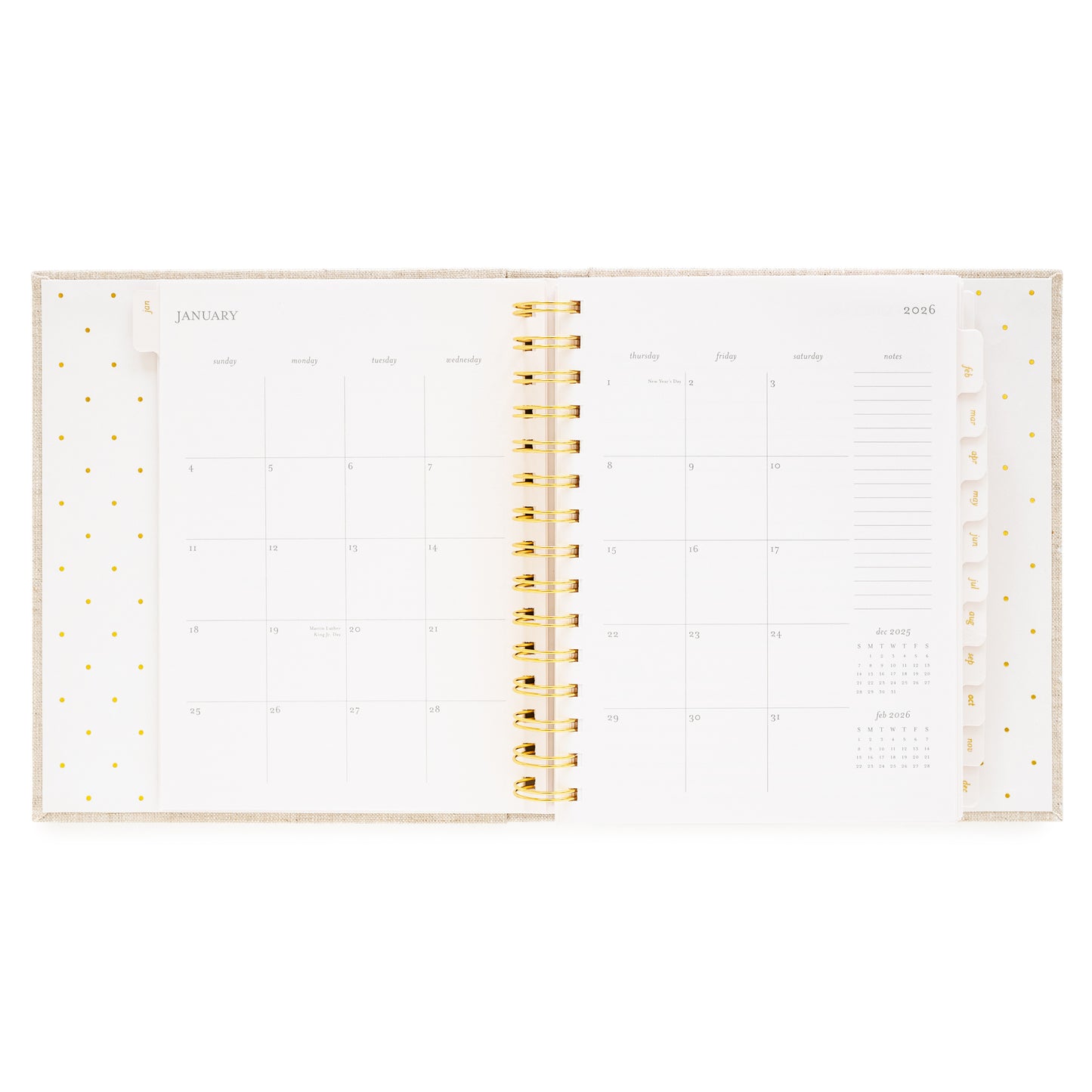 Open concealed agenda with gold spiral and monthly grid layout for January 2026