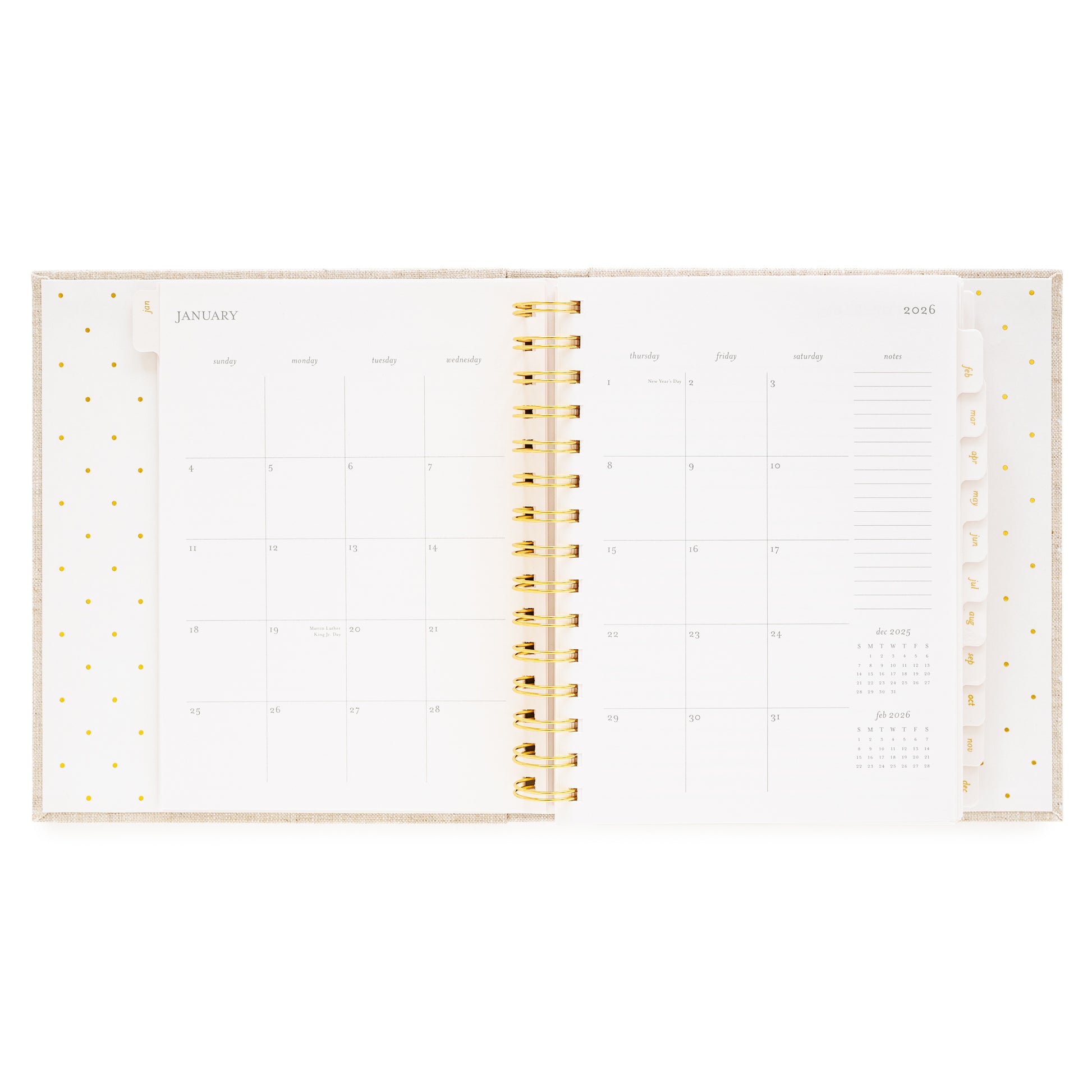Open concealed agenda with gold spiral and monthly grid layout for January 2026
