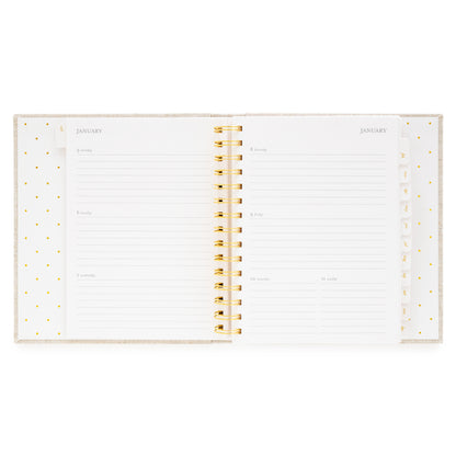 Open concealed agenda with gold spiral to weekly layout with space for each day of the week